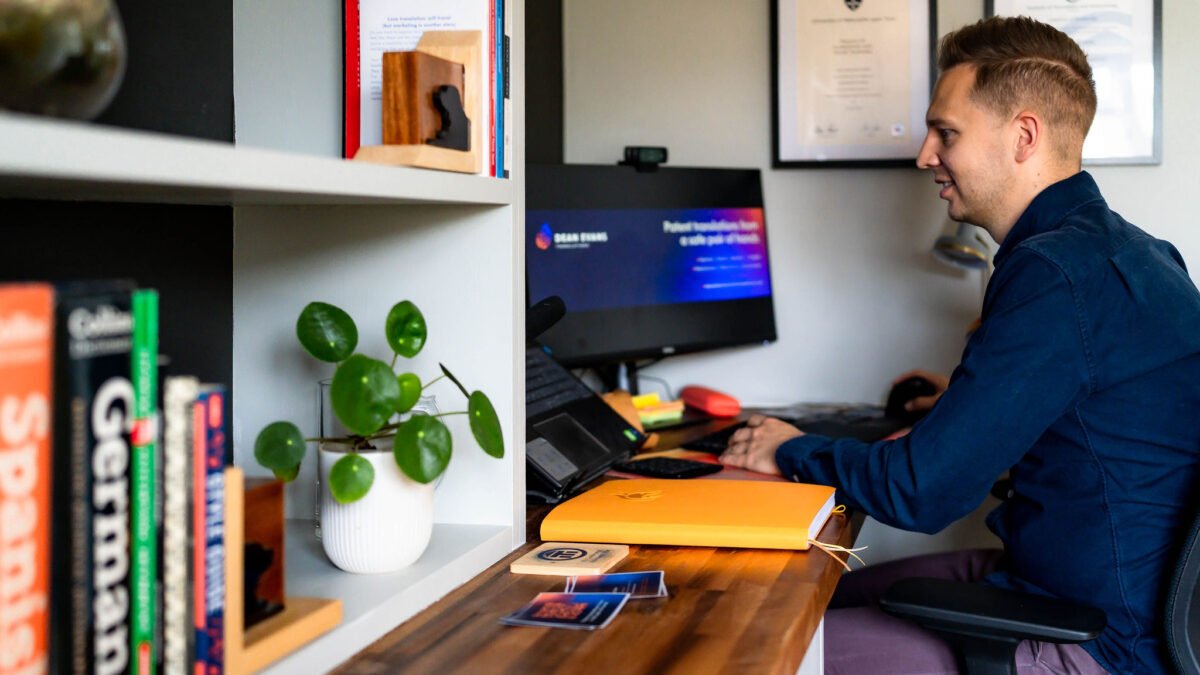 An image of Dean Evans working at his computer. The computer background reads "Patent translations from a safe pair of hands"